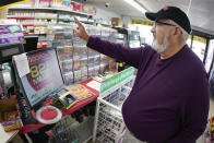 Dave Colbert, from Johnstown, Pa, buys a ticket for the Saturday, Oct. 29, drawing of the Powerball lottery at a market in Prospect, Pa., Friday, Oct. 28, 2022, Saturday's jackpot projected winnings of an estimated $825 million is the fifth-highest in U.S. history. (AP Photo/Keith Srakocic)