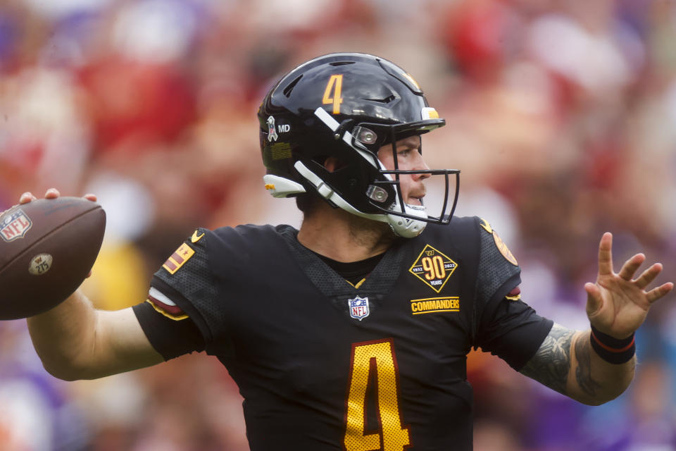 Washington Commanders quarterback Taylor Heinicke (4) looks to make a pass during the first half of a NFL football game between the Washington Commanders and the Minnesota Vikings on Sunday, Nov. 6, 2022 in Landover, Md. (Shaban Athuman/Richmond Times-Dispatch via AP)