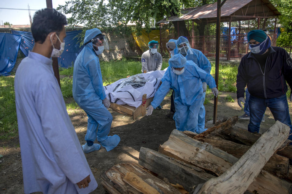 Relatives and volunteers carry the body of a Covid victim at a crematorium in Srinagar, Indian, controlled Kashmir, last May.  (Dar Yasin / AP file)