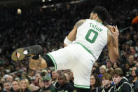 Boston Celtics' Jayson Tatum saves the ball from going out of bounds during the first half of an NBA basketball game against the Milwaukee Bucks, Thursday, March 30, 2023, in Milwaukee. (AP Photo/Aaron Gash)
