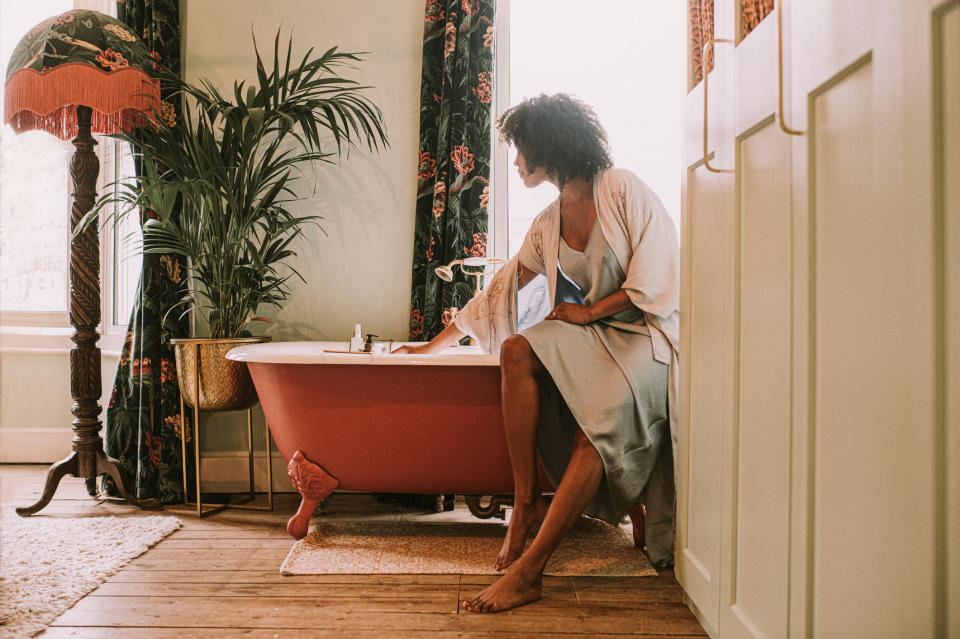 Woman running a bath. (Getty Images)