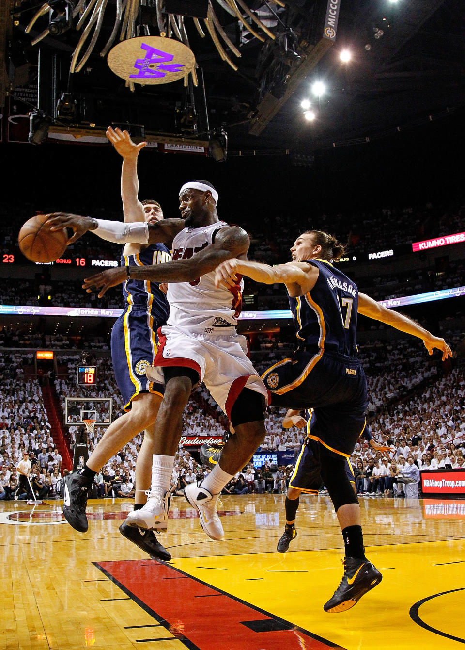 MIAMI, FL - MAY 22: LeBron James #6 of the Miami Heat passes away from Tyler Hansbrough #50 and Louis Amundson #17 of the Indiana Pacers during Game Five of the Eastern Conference Semifinals in the 2012 NBA Playoffs at AmericanAirlines Arena on May 22, 2012 in Miami, Florida. NOTE TO USER: User expressly acknowledges and agrees that, by downloading and/or using this Photograph, User is consenting to the terms and conditions of the Getty Images License Agreement. (Photo by Mike Ehrmann/Getty Images)