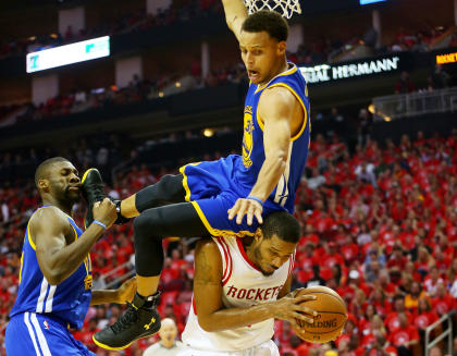 Stephen Curry fell over Trevor Ariza before crashing to the court. (Getty Images)