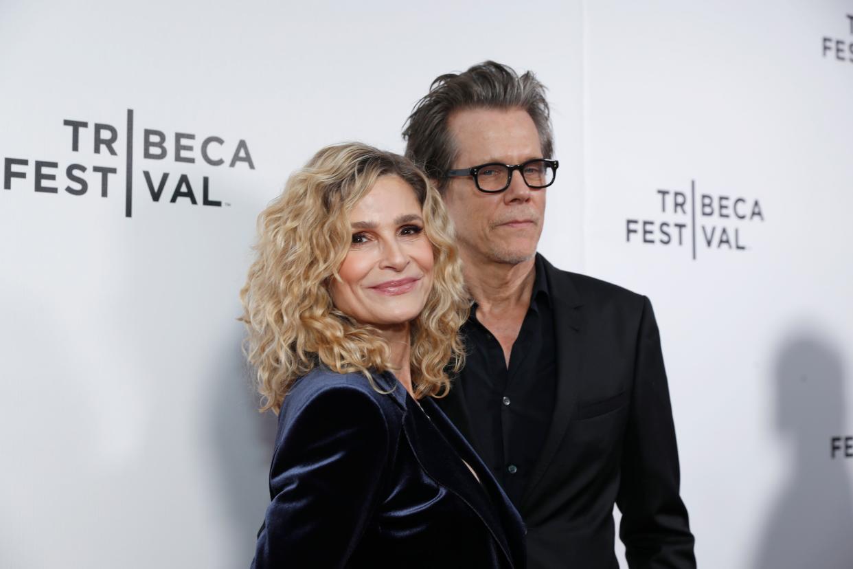 Kyra Sedgwick standing next to Kevin Bacon