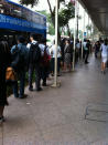 A queue snakes down from the bus stop outside Plaza Singapura at Dhoby Ghaut station as commuters wait to board bridging buses. (Yahoo! photo/Lin Wenjian)