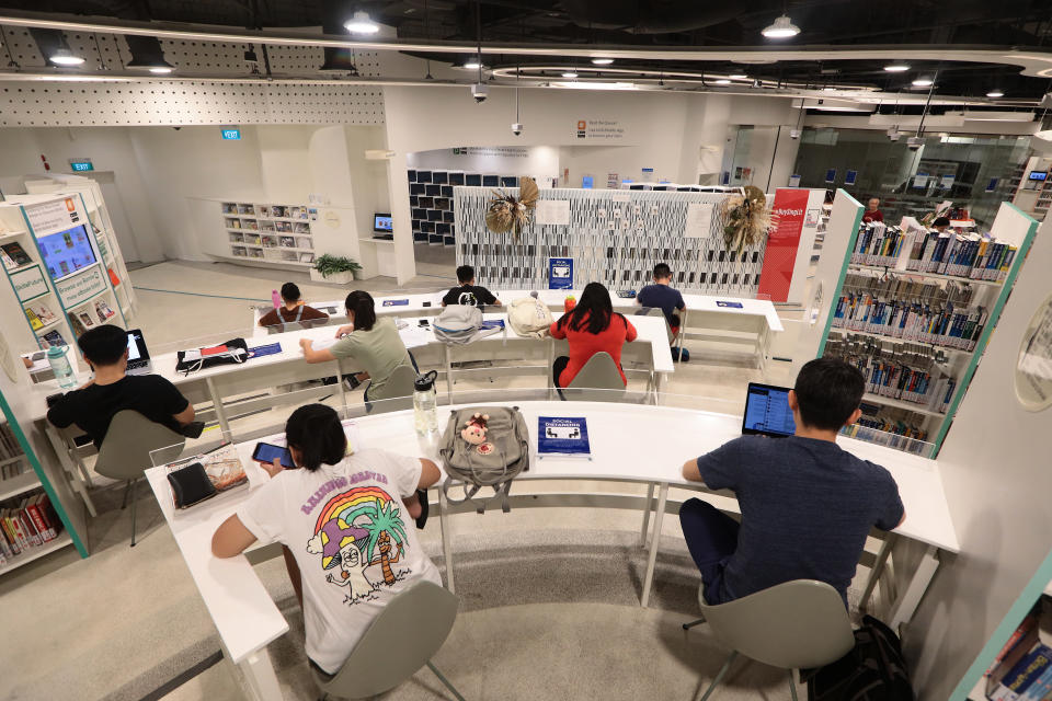 People studying in a public library are seated apart as part of social distancing measures on 19 March, 2020, in Singapore. (PHOTO: Getty Images)