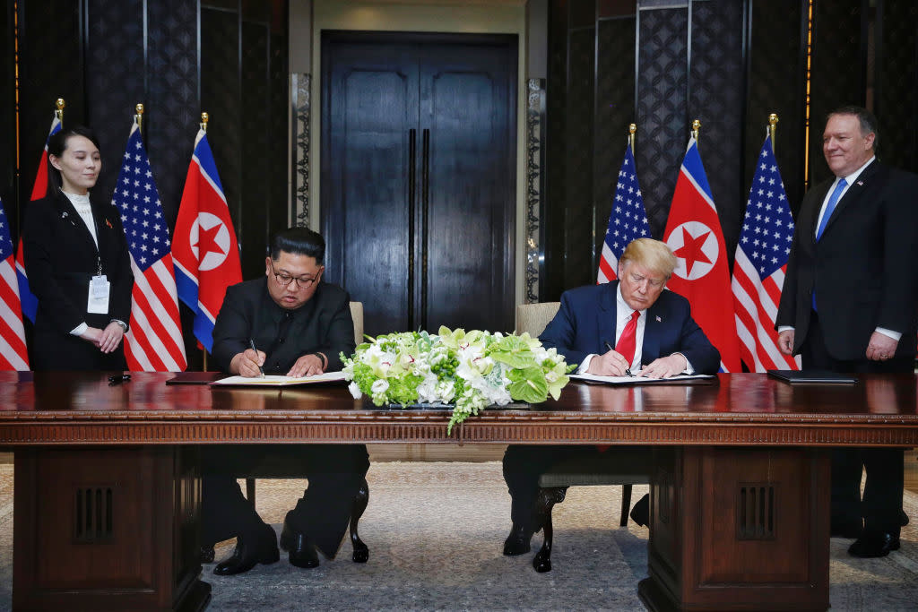 Kim Jong-un and Donald Trump sign their agreement in Singapore (Picture: Getty)