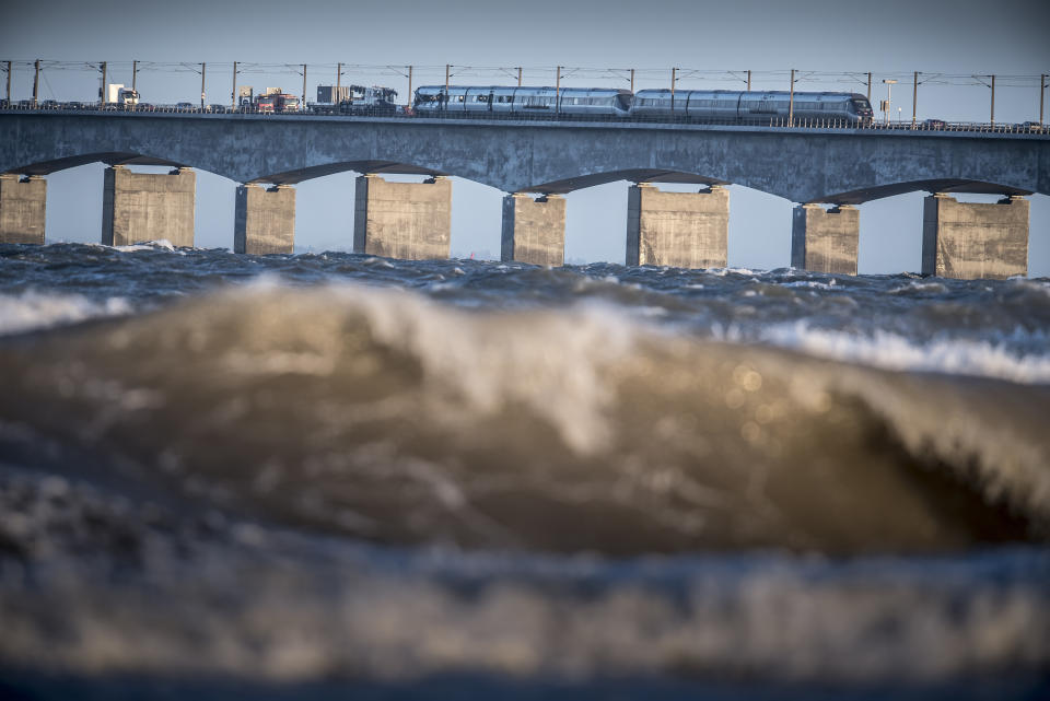 A view of the scene after a train accident on the Great Belt Bridge in Nyborg, Denmark, Wednesday, Jan. 2, 2019. A Danish passenger train apparently hit falling cargo from a passing freight train Wednesday, an accident that killed six people and injured 16 others as it crossed a bridge linking the country's islands, authorities said. Authorities said the trains were going past each other in opposite directions. Aerial TV footage showed one side of front of the passenger train had been ripped open. (Mads Claus Rasmussen/Ritzau Scanpix via AP)