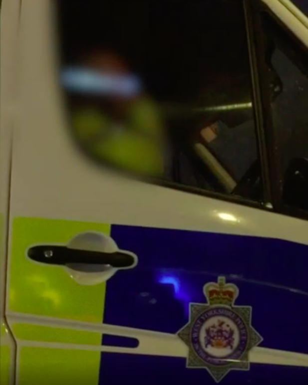 <em>The police officer was filmed using his mobile phone while sitting at lights (Grab)</em>