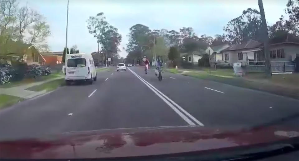 The rider's stunt on a busy road in Sydney's Macquarie Fields was captured on dashcam. Source: Dash Cam Owners Australia/ Facebook