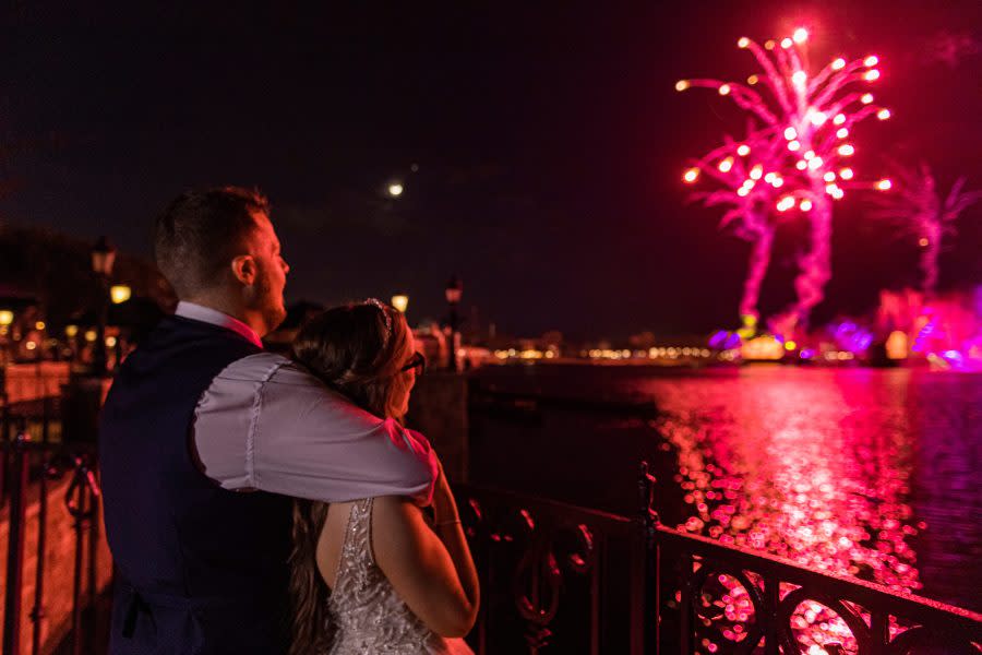 Bride Kristin Robinson, who is colorblind, closes out her wedding celebration by experiencing the EPCOT nighttime spectacular, “Harmonious” in color for the first time. Prior to her wedding on January 25, 2023, Robinson donned a special pair of glasses that enabled her to see color at Walt Disney World Resort in Lake Buena Vista, Fla. (Abigail Nilsson, photographer)