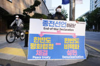 A man, holding a banner, stands to denounce policies of the United States and South Korean government on North Korea in Seoul, South Korea, Sunday, Oct. 24, 2021. A senior U.S. diplomat on Sunday urged North Korea to end a recent series of missile tests and resume negotiations, days after the North performed its first underwater-launched ballistic missile launch in two years. (AP Photo/Ahn Young-joon)