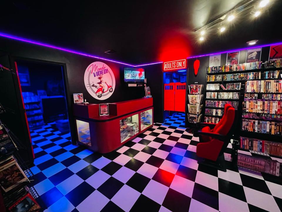 A photo of the main room in the basement, including the checkout counter and 'Adults Only' section.