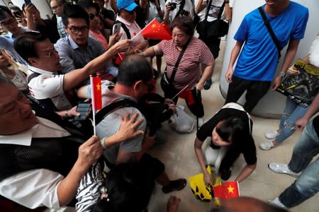 Pro-government and anti-government supporters chant against one another at a shopping mall in Hong Kong