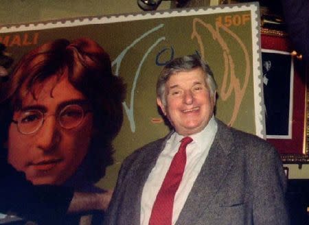 Former Beatles' promoter Sid Bernstein stands with new stamps at a John Lennon World Postal Tribute in New York, New York, December 8, 1995. REUTERS/Mark Cardwell/File Photo