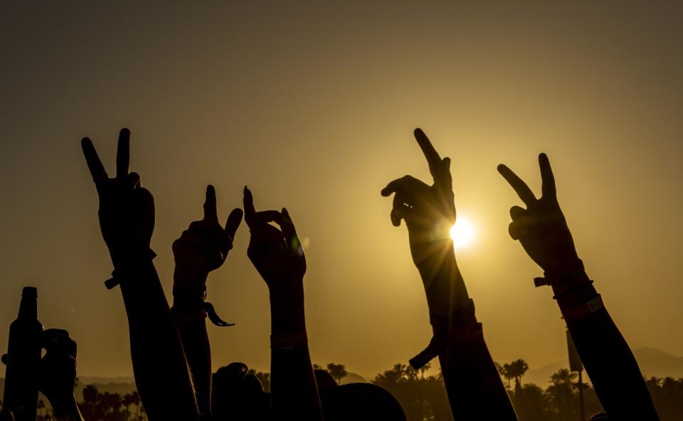 Fans wave their hands in the air.