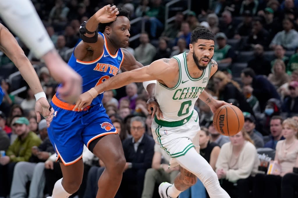 Boston Celtics forward Jayson Tatum (0) drives toward the basket as New York Knicks forward OG Anunoby (8) defends during the first half of an NBA basketball game Thursday, April 11, 2024, in Boston. (AP Photo/Steven Senne)