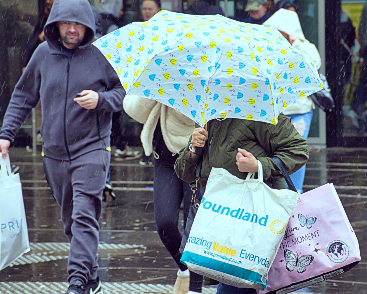 Glasgow, Scotland, UK. 13h April, 2024: UK Weather:  Wet and Windy in the city as people struggled on the shopping capital and style mile of Scotland, Buchanan Street. Credit Gerard Ferry/Alamy Live News