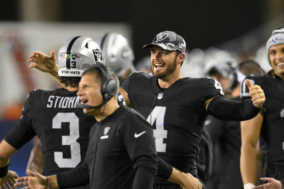 Las Vegas Raiders quarterback Derek Carr (4) celebrates with quarterback Jarrett Stidham (3), who ran for a touchdown during the first half of the team's NFL football exhibition Hall of Fame Game against the Jacksonville Jaguars, Thursday, Aug. 4, 2022, in Canton, Ohio. (AP Photo/David Richard)