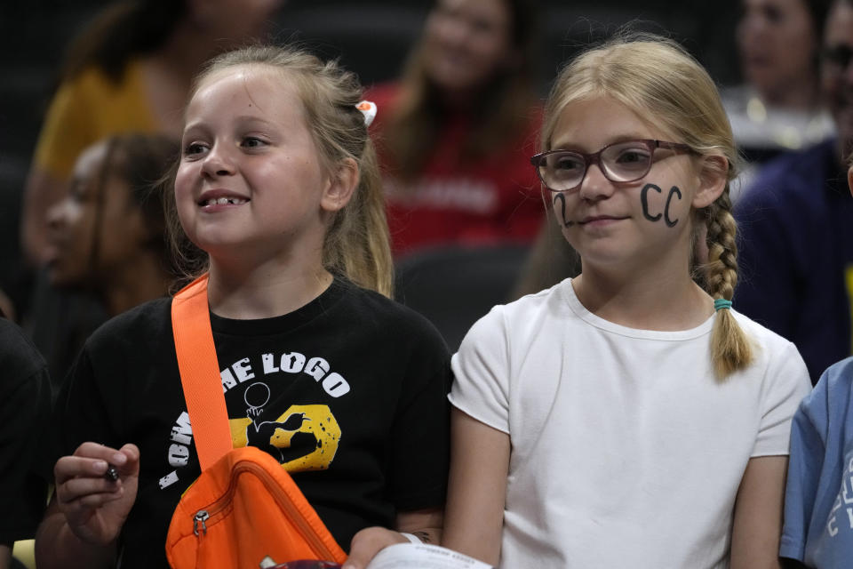 Fans watch Indiana Fever guard Caitlin Clark warm up before a WNBA basketball game against the New York Liberty, Thursday, May 16, 2024, in Indianapolis. (AP Photo/Michael Conroy)