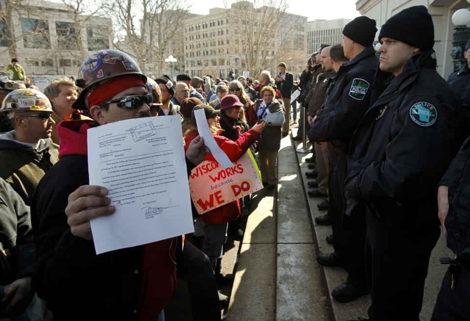 Randy Bryce holds up a court order to open the doors of the state Capitol, Madison, Wis., March 1, 2011. (Photo: Andy Manis)