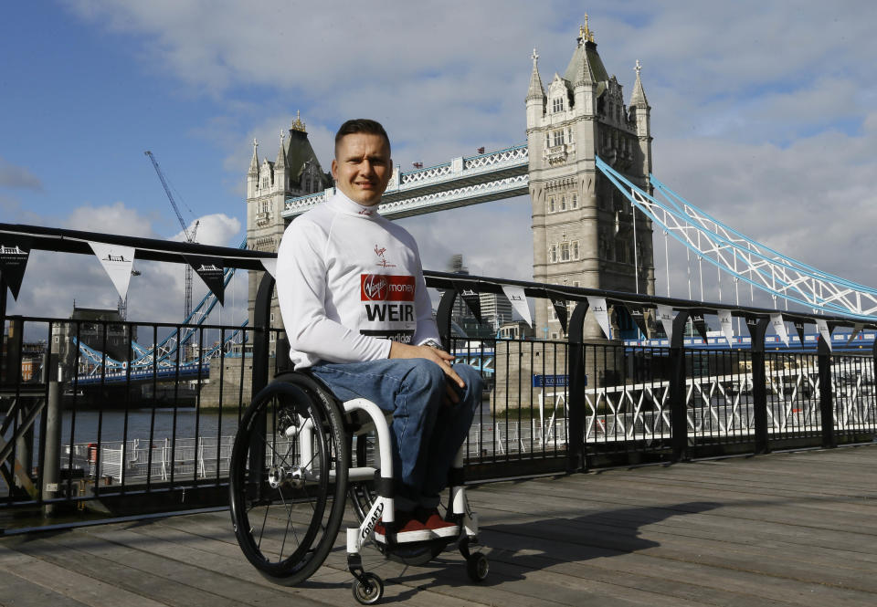 British elite wheelchair athlete David Weir poses for the media in front of Tower Bridge in London, Friday, April 19, 2013. The London Marathon will go ahead on Sunday despite security fears in the wake of the bomb blasts in the Boston race that killed at least three runners and injured many more. (AP Photo/Kirsty Wigglesworth)