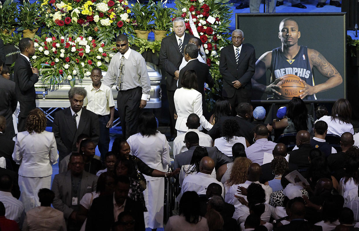 Friends and family of slain NBA basketball player Lorenzen Wright grieve at the casket of Wright.