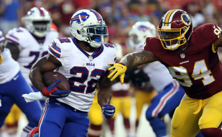 Aug 26, 2016; Landover, MD, USA; Buffalo Bills running back Reggie Bush (22) carries the ball as Washington Redskins defensive end Preston Smith (94) chases in the first quarter at FedEx Field. Mandatory Credit: Geoff Burke-USA TODAY Sports