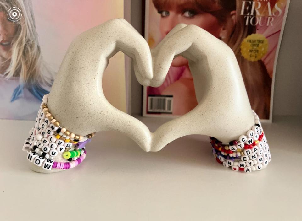 A 14-year-old fan of Taylor Swift displays her Taylor Swift friendship bracelets she made herself on a shelf with her other Swift merch.