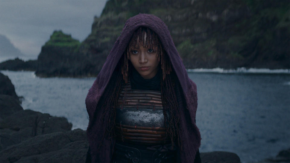 Mae (Amandla Stenberg) standing in front of the sea in The Acolyte.