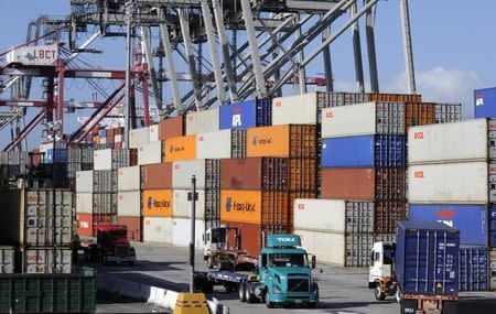 Semi trucks and containers wait at the Port of Long Beach October 27, 2014. REUTERS/Bob Riha Jr.