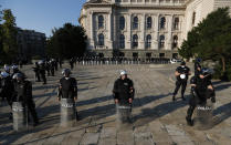 Riot police guards the area in front of the Serbian Parliament building as people gather for a demonstration in Belgrade, Serbia, Wednesday, July 8, 2020. Serbia's president Aleksandar Vucic backtracked Wednesday on his plans to reinstate a coronavirus lockdown in Belgrade after thousands protested the move and violently clashed with the police in the capital. (AP Photo/Darko Vojinovic)