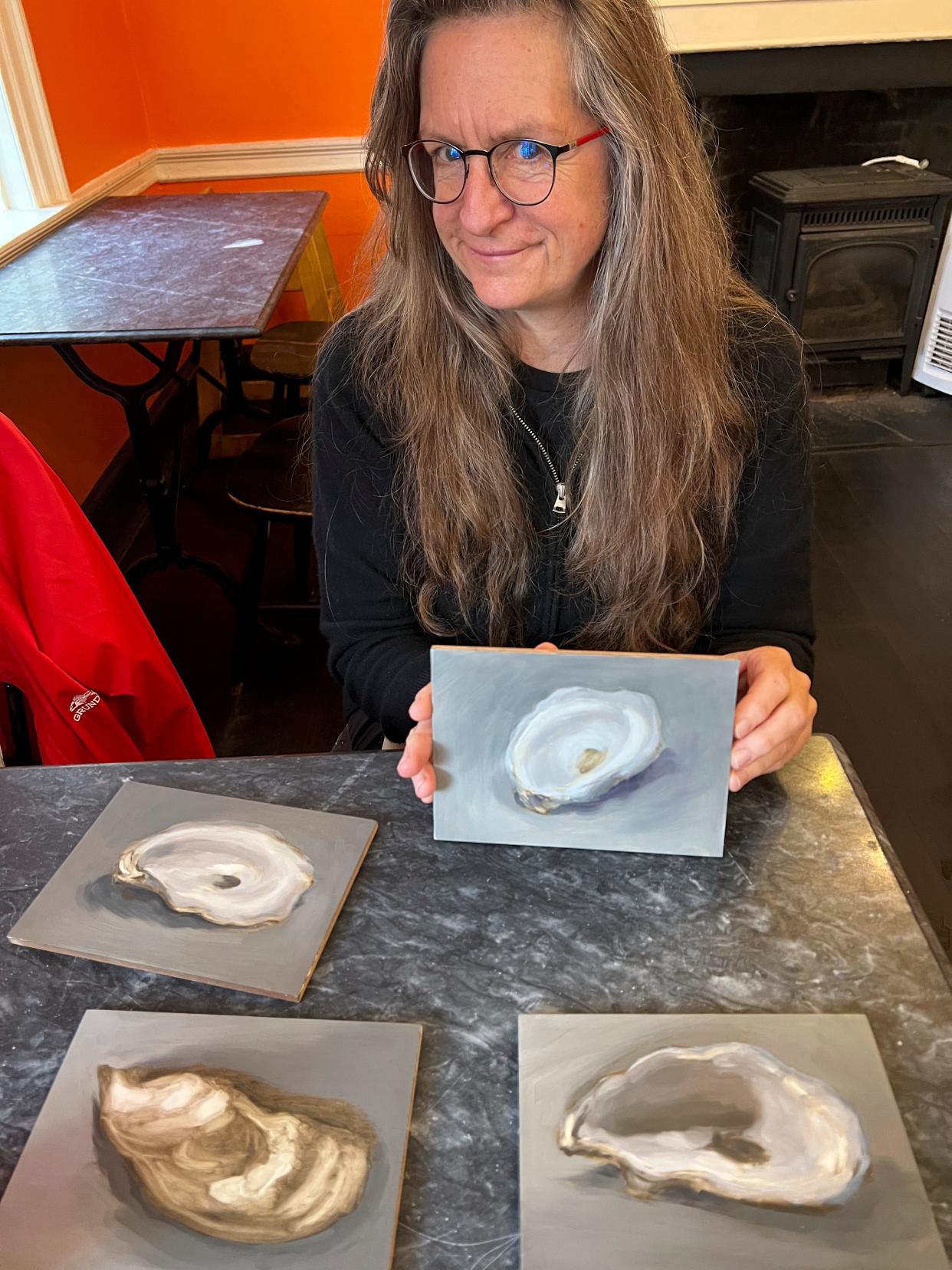 Cleo Huggins with oyster shells paintings.