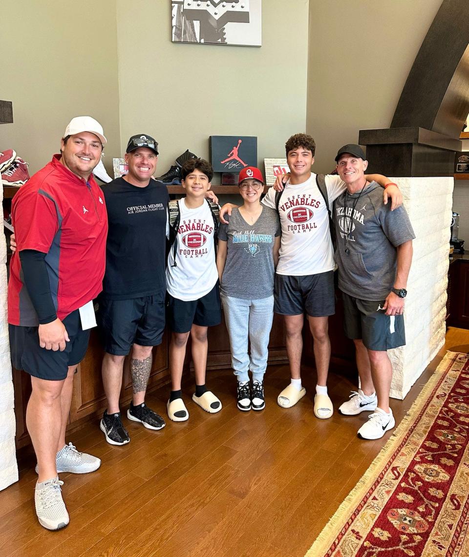 Carl Albert quarterback Kevin Sperry (second from right) and family members pose for a photo with OU football coach Brent Venables (right) and offensive coordinator Jeff Lebby (left) on June 3.