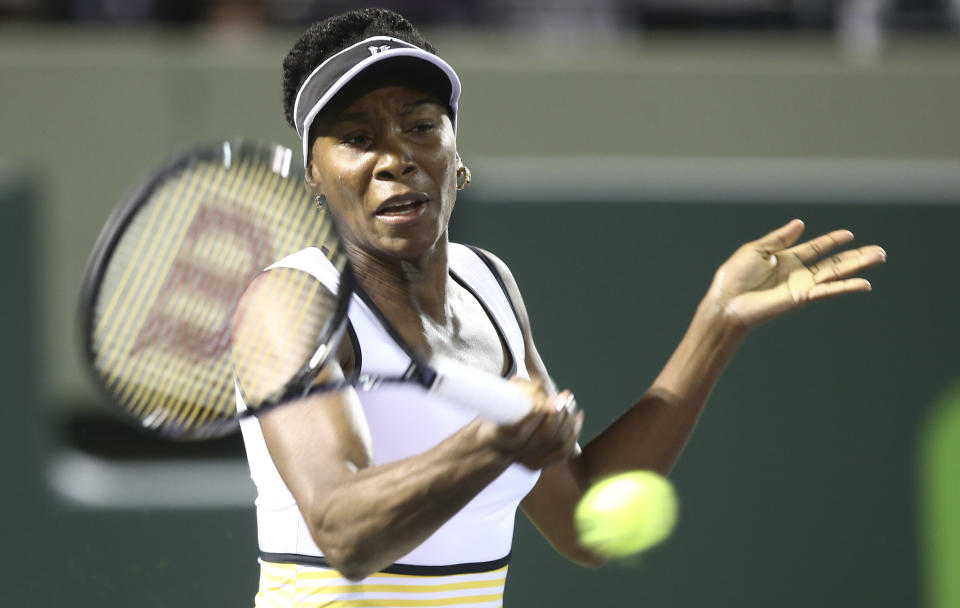 Venus Williams, of the United States, retuns the ball to Dominika Cibulkova, of Slovakia,during the Sony Open Tennis in Key Biscayne, Fla., Monday, March 24, 2014. (AP Photo/J Pat Carter)