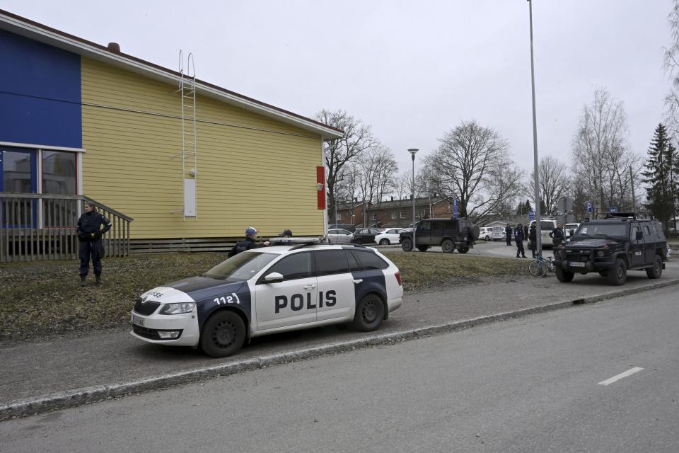 Police officers and vehicles at the scene of Viertola comprehensive school, in Vantaa, Finland, Tuesday, April 2, 2024. Finnish police say a number of people were wounded in a shooting at a school outside Helsinki and a suspect was detained. (Markku Ulander/Lehtikuva via AP)