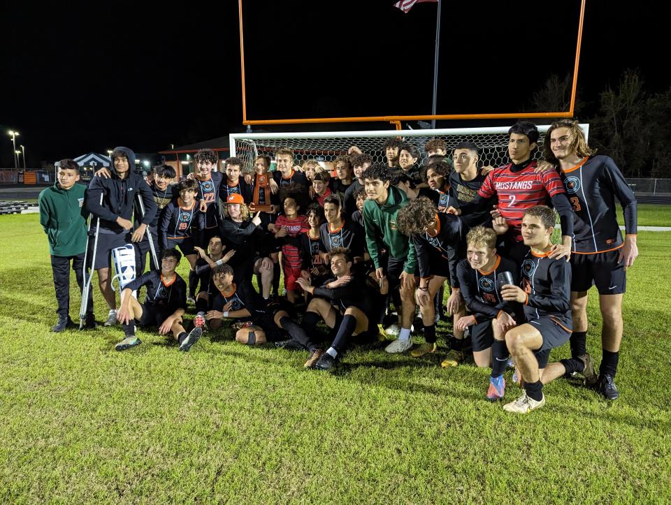 Mandarin players celebrate after defeating Bartram Trail for the FHSAA District 1-7A boys soccer championship on February 2, 2023. [Clayton Freeman/Florida Times-Union]