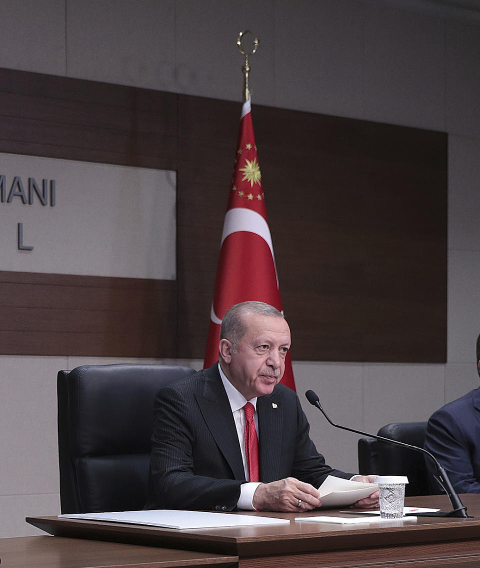 Turkey's President Recep Tayyip Erdogan speaks to the media before traveling to Azerbaijan, in Istanbul, Monday, Oct. 14, 2019. Erdogan has criticized NATO allies which are looking to broaden an arms embargo against Turkey over its push into northern Syria. (Presidential Press Service/Pool Photo via AP)