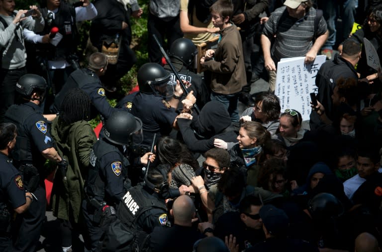 Police and protesters clash outside the Hyatt Regency Hotel where US Republican presidential candidate Donald Trump was speaking in Burlingame, California on April 29, 2016