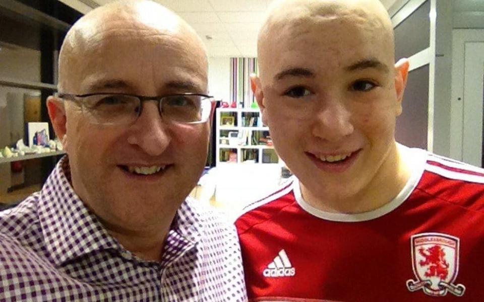 Nigel Maguire (left) with his son Lewis whom he believes contracted cancer from artificial pitch rubber pellets - Cascade News