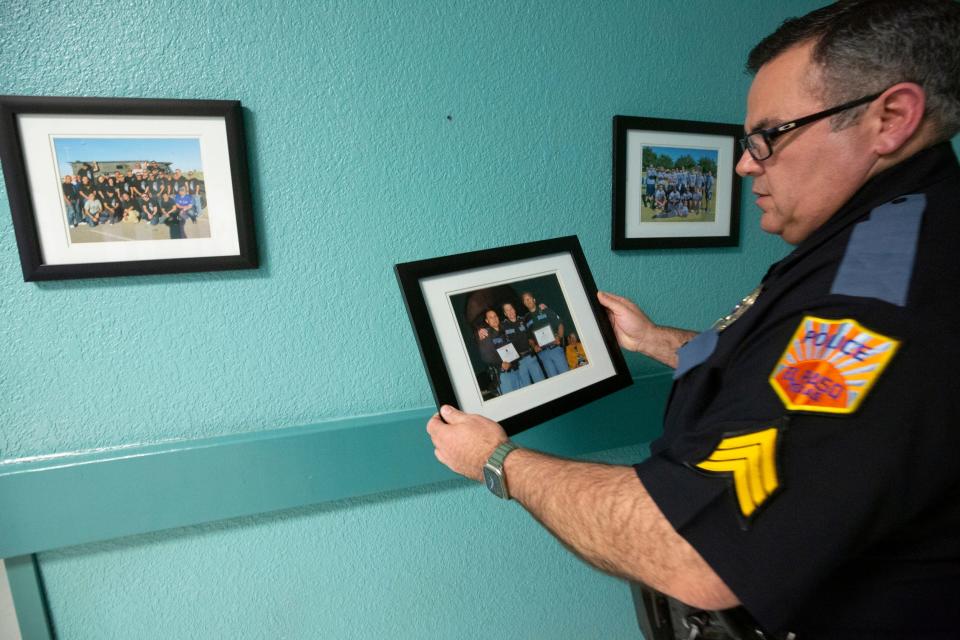 Sgt. Robert Gomez, of the El Paso Police Department, looks at a photograph of late police Chief Greg Allen on Tuesday at the Mission Valley Regional Command Center.