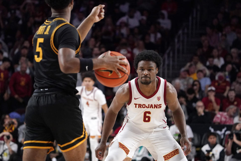 Long Beach State guard Jason Hart Jr., left, dribble as Southern California guard Bronny James defends during the first half of an NCAA college basketball game Sunday, Dec. 10, 2023, in Los Angeles. (AP Photo/Mark J. Terrill)