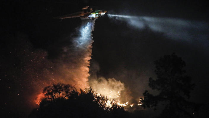 Los Angeles County fire crews battle a brush fire in the foothills of Azusa, Calif.