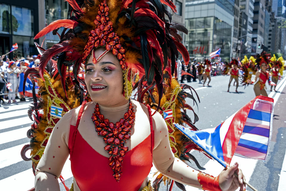 A member of a parade unit entertains spectators during the National Puerto Rican Day Parade Sunday, June 9, 2019, in New York. (AP Photo/Craig Ruttle)
