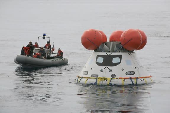 An inflatable boat carrying U.S. Navy personnel approaches the Orion boilerplate test device on Aug. 2 off the coast of California.
