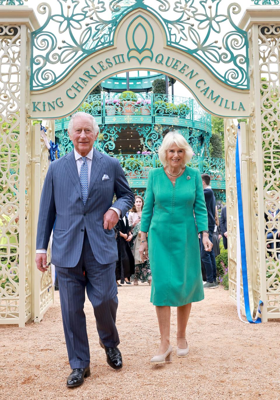 King Charles and Queen Camilla walk under a gate in Northern Ireland