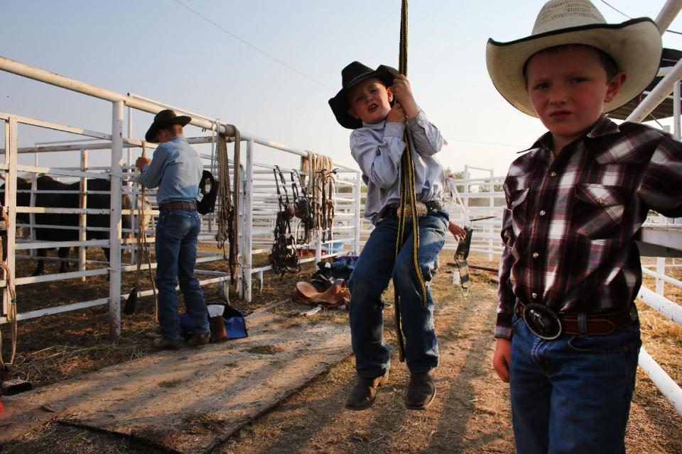 FILE - In this Aug. 16, 2013 file photo, young cowboys prepare to compete in the annual rodeo in Deer Trail, Colo. This rural town an hour east of Denver that calls itself home of the world’s first rodeo has an unusual special election happening on April 1, 2014: Should the city issue hunting licenses to shoot down unmanned aerial drones? (AP Photo/Brennan Linsley, file)