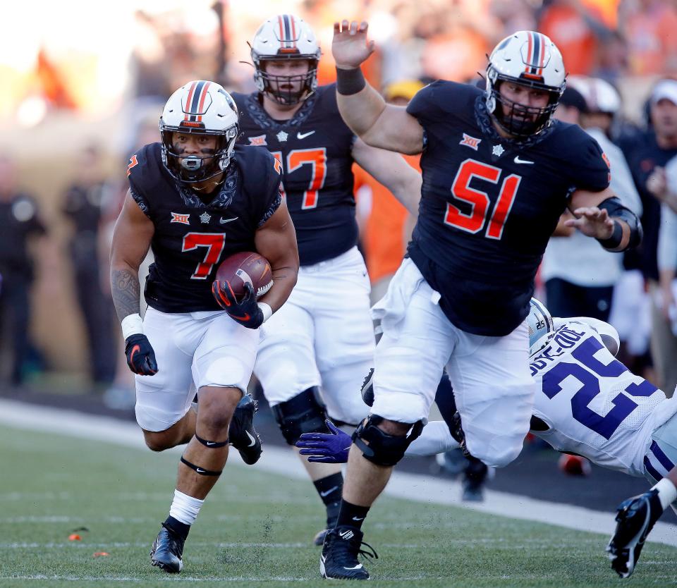 Oklahoma State's Jaylen Warren (7) runs the ball behind a block from Danny Godlevske (51) in a game against Kansas State in September. Both Warren and Godlevske are transfers who have found starting roles at OSU this season.