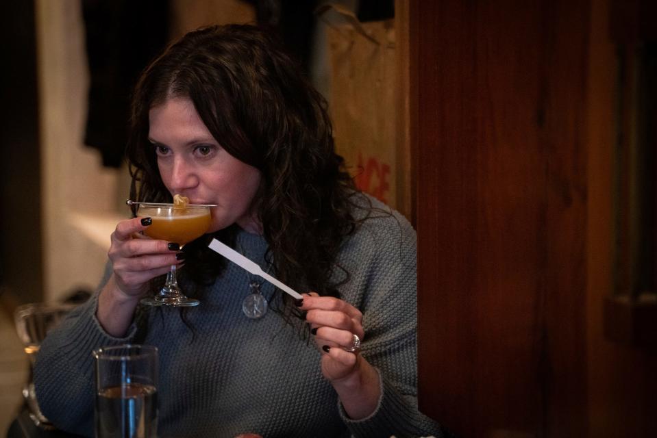 Emily Ross, of Ann Arbor, sips an alcohol-free cocktail called “Iroh Knows Best” with papaya nectar, lime and ginger tea at Sfumato Fragrances, a perfumery by day and bar by night, in Detroit’s Midtown on January 11, 2023.