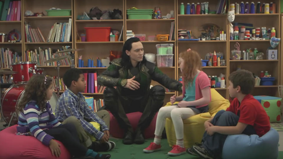 Tom Hiddleston pushes a young girl among a circle of kids in Thor: The Dark World.